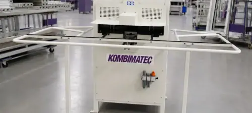 Kombimatec EV443/CNC compact CNC corner cleaning machine designed for uPVC window and door fabricators in a factory environment.